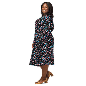 A person wearing a NerdyKeppie Raveyard Ghosts Trans Pride Long Sleeve Midi Dress With Pockets. 