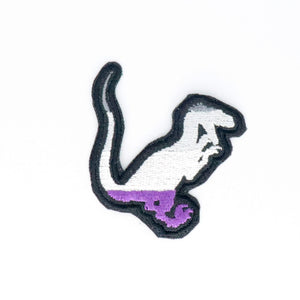 NerdyKeppie's Ace Velociraptor Embroidered Pride Patch are shaped like their namesake and stitched on black duck cloth!