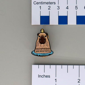 NerdyKeppie All Capybaras Are Beautiful ACAB Enamel Pin. A capybara being mellow in a pool captioned with the phrase all capybaras are beautiful. Get your all capybaras are beautiful ACAB enamel pins here!