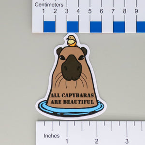 NerdyKeppie "All Capybaras are Beautiful" ACAB Stickers. NerdyKeppie's "All Capybaras Are Beautiful" ACAB Stickers feature a brown capybara with a bird on its head. Printed on its chest are the words All Capybaras Are Beautiful.