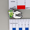 NerdyKeppie Proud to the Bone Cave Bear Skull Pride Enamel Pins. A Cave Bear skull pride enamel pin for our Proud to the Bone project. This prehistoric pin is wearing an adorable crown of flowers!