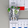 NerdyKeppie Proud to the Bone Human Ribcage Pride Enamel Pins. A human ribcage pride enamel pin for our Proud to the Bone project, wearing an adorable crown of flowers!