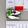 NerdyKeppie Proud to the Bone Tyrannosaurus Rex Skull Pride Enamel Pins. A Tyrannosaurus Rex skull pride enamel pin for our Proud to the Bone project. This prehistoric T-Rex pin is wearing an adorable crown of flowers!