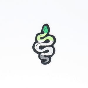 NerdyKeppie's Aro Snake Embroidered Pride Patch are shaped like their namesake and stitched on black duck cloth!