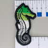 NerdyKeppie's BONEYARD Seahorse Embroidered Pride Patch are shaped like their namesake and stitched on black duck cloth!