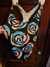 A person wearing a NerdyKeppie BONEYARD Trans Pride Stencil Roses Pride Tank Swimsuit Without Skirt - 2X. A pair of joggers with two deep pockets, its Neon Tarot pattern is in non-binary or genderfluid flag colors. These pride jogger sweatpants have a relaxed fit in the waist, hips, and thighs.