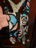A person wearing a NerdyKeppie BONEYARD Trans Pride Stencil Roses Pride Tank Swimsuit Without Skirt - 2X. A pair of joggers with two deep pockets, its Neon Tarot pattern is in non-binary or genderfluid flag colors. These pride jogger sweatpants have a relaxed fit in the waist, hips, and thighs.