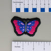 NerdyKeppie's Bi Psychedelic Butterfly Embroidered Pride Patch are shaped like their namesake and stitched on black duck cloth!
