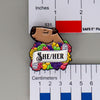 NerdyKeppie Capybara Enamel Lesbian Pride Pronoun Pins. Our enamel pin features an adorable capybara, a paper scroll with four different pronoun choices, and flowers in lesbian pride colors. This pride pin ships from Portland, Oregon.