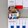 NerdyKeppie Capybara Enamel Progress Pride Pronoun Pins. Our enamel pin features an adorable capybara, a paper scroll with six different pronoun choices, and flowers in Progress pride colors. This pride pin ships from Portland, Oregon.
