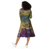 A person wearing a NerdyKeppie Carina Nebula Pan Pride Long Sleeve Midi Dress With Pockets. 