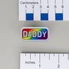 NerdyKeppie "DADDY" Mirrored Pride Pin. Mirrored pride pin with "DADDY" text in your choice of bear, gay men's / MLM, rainbow, or transgender pride colors. Say it with your whole chest.