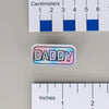 NerdyKeppie "DADDY" Mirrored Pride Pin. Mirrored pride pin with "DADDY" text in your choice of bear, gay men's / MLM, rainbow, or transgender pride colors. Say it with your whole chest.