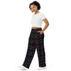 A person wearing a NerdyKeppie Dino Bones Progress Pride Unisex Wide-Leg Pants With Pockets. 