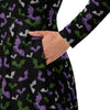 A person wearing a NerdyKeppie Engraved Bats Genderqueer Pride Long Sleeve Midi Dress With Pockets. 
