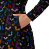 A person wearing a NerdyKeppie Engraved Bats Progress Pride Long Sleeve Midi Dress With Pockets. 