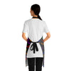 A person wearing a NerdyKeppie Engraved Bats Rainbow Gay Pride Apron With Pocket. A black apron with an Engraved Bats design on it in rainbow gay pride colors. This rainbow gay pride pocket apron is made of durable 100% polyester.