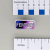NerdyKeppie "FEMBOY" Mirrored Pride Pin. Mirrored pride pin with "FEMBOY" text, available in genderfluid, non-binary, rainbow, or transgender pride. Say it with your whole chest.