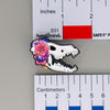 NerdyKeppie Proud to the Bone Dire Wolf Skull Pride Enamel Pins. A Dire Wolf skull pride enamel pin for our Proud to the Bone project. This prehistoric pin is wearing an adorable crown of flowers!