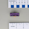 NerdyKeppie Lavender Menace Enamel Pins. Our Lavender Menace Enamel Pins reads "LAVENDER MENACE" in a purple typewriter font. Each pin uses soft enamel color fill on a black metal backing and ships from Portland, Oregon USA.