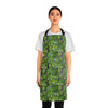 A person wearing a NerdyKeppie Lemurs Progress Pride Apron With Pocket. A sturdy poly twill apron with a pattern of lemurs and foliage on it. This pride pocket apron has an adjustable neck and two pockets.