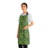 A person wearing a NerdyKeppie Lemurs Progress Pride Apron With Pocket. A sturdy poly twill apron with a pattern of lemurs and foliage on it. This pride pocket apron has an adjustable neck and two pockets.