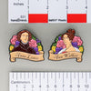 NerdyKeppie Ann & Anne Historically Queer Enamel Pride Pin Set. Our NerdyKeppie Historically Queer Pride enamel pin features Anne Lister and Ann Walker surrounded by flowers in your choice of lesbian or rainbow pride colors. This pride pin ships from Portland, Oregon.