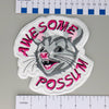 NerdyKeppie's No Hooked Backing "Awesome Possum" Embroidered Patch are stitched on black duck cloth and backed by sturdy vinyl fuse.