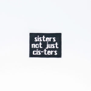 NerdyKeppie's No Hooked Backing "Sisters Not Just Cis-Ters" Embroidered Trans Pride Patch are stitched on black duck cloth and backed by sturdy vinyl fuse.