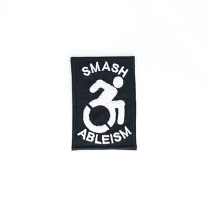 NerdyKeppie's No Hooked Backing "Smash Ableism" Embroidered Disability Pride Patch are stitched on black duck cloth and backed by sturdy vinyl fuse.
