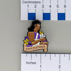 NerdyKeppie Enheduanna Historically Queer Enamel Pride Pin. Our NerdyKeppie Historically Queer Pride enamel pin features Enheduanna surrounded by flowers in your choice of transgender, non-binary, or Spirit of '77 pride colors. This pride pin ships from Portland, Oregon.