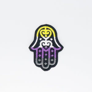 NerdyKeppie's Non-Binary Hamsa Embroidered Pride Patch are stitched on black duck cloth and backed by sturdy vinyl fuse.