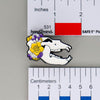 NerdyKeppie Proud to the Bone Cave Bear Skull Pride Enamel Pins. A Cave Bear skull pride enamel pin for our Proud to the Bone project. This prehistoric pin is wearing an adorable crown of flowers!