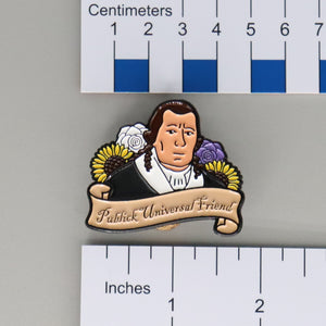 NerdyKeppie Publick Universal Friend Historically Queer Enamel Pride Pin. Our NerdyKeppie Historically Queer Pride enamel pin features Publick Universal Friend surrounded by flowers in your choice of non-binary or transgender pride colors. This pride pin ships from Portland, Oregon.