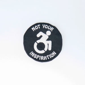 NerdyKeppie's "Not Your Inspiration" Embroidered Disability Pride Patch are stitched on black duck cloth and backed by sturdy vinyl fuse.