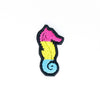 NerdyKeppie's Pan Seahorse Embroidered Pride Patch are shaped like their namesake and stitched on black duck cloth!