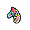 NerdyKeppie's Pan Zebra Embroidered Pride Patch are shaped like their namesake and stitched on black duck cloth!