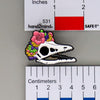 NerdyKeppie Proud to the Bone Archaeopteryx Skull Pride Enamel Pins. An archaeopteryx skull pride enamel pin for our Proud to the Bone project. This prehistoric pin is wearing an adorable crown of flowers!