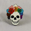 NerdyKeppie Proud to the Bone Glow-in-the-Dark Human Skull Progress Pride Enamel Pin. An adorable glowing skull enamel pin wearing a Progress Pride flower crown. This 1.25" pin makes a perfect gift for all pin collectors!