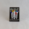 NerdyKeppie Proud to the Bone Human Ribcage Pride Enamel Pins. A human ribcage pride enamel pin for our Proud to the Bone project, wearing an adorable crown of flowers!