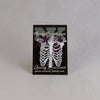 NerdyKeppie Proud to the Bone Human Ribcage Pride Enamel Pins. A human ribcage pride enamel pin for our Proud to the Bone project, wearing an adorable crown of flowers!