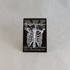 NerdyKeppie Proud to the Bone Human Ribcage Pride Enamel Pins. A human ribcage pride enamel pin for our Proud to the Bone project, wearing an adorable crown of flowers!