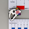NerdyKeppie Proud to the Bone Sabertooth Tiger Skull Pride Enamel Pins. A Sabertooth Tiger skull pride enamel pin for our Proud to the Bone project, a perfect prehistoric gift for your favorite nerd. This prehistoric pin wears an adorable flower crown!