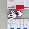 NerdyKeppie Proud to the Bone Triceratops Skull Pride Enamel Pins. A Triceratops skull pride enamel pin for our Proud to the Bone project. This prehistoric pin is wearing an adorable crown of flowers!