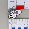NerdyKeppie Proud to the Bone Triceratops Skull Pride Enamel Pins. A Triceratops skull pride enamel pin for our Proud to the Bone project. This prehistoric pin is wearing an adorable crown of flowers!