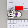 NerdyKeppie Proud to the Bone Triceratops Skull Pride Enamel Pins. A Triceratops skull pride enamel pin for our Proud to the Bone project. This prehistoric pin is wearing an adorable crown of flowers!