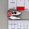 NerdyKeppie Proud to the Bone Tyrannosaurus Rex Skull Pride Enamel Pins. A Tyrannosaurus Rex skull pride enamel pin for our Proud to the Bone project. This prehistoric T-Rex pin is wearing an adorable crown of flowers!