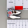 NerdyKeppie Proud to the Bone Tyrannosaurus Rex Skull Pride Enamel Pins. A Tyrannosaurus Rex skull pride enamel pin for our Proud to the Bone project. This prehistoric T-Rex pin is wearing an adorable crown of flowers!
