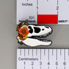 NerdyKeppie Proud to the Bone Tyrannosaurus Rex Skull Pride Enamel Pins. A Tyrannosaurus Rex skull pride enamel pin for our Proud to the Bone project. This prehistoric T-Rex pin is wearing an adorable crown of flowers!