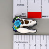 NerdyKeppie Proud to the Bone Tyrannosaurus Rex Skull Pride Enamel Pins. A Tyrannosaurus Rex skull pride enamel pin for our Proud to the Bone project. This prehistoric T-Rex pin is wearing an adorable crown of flowers!